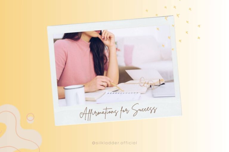 A close-up of a woman in a pink sweater, deep in thought, as she writes in a notebook on a desk filled with papers and a coffee mug. The background is framed with light-colored abstract designs, and the text "Affirmations for Success" is shown at the bottom in elegant cursive.